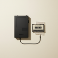 Portable cassette player with tape flat lay on cream background